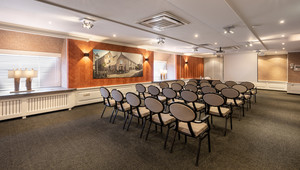 Meeting room in theater setup with Nespresso machine and fridge